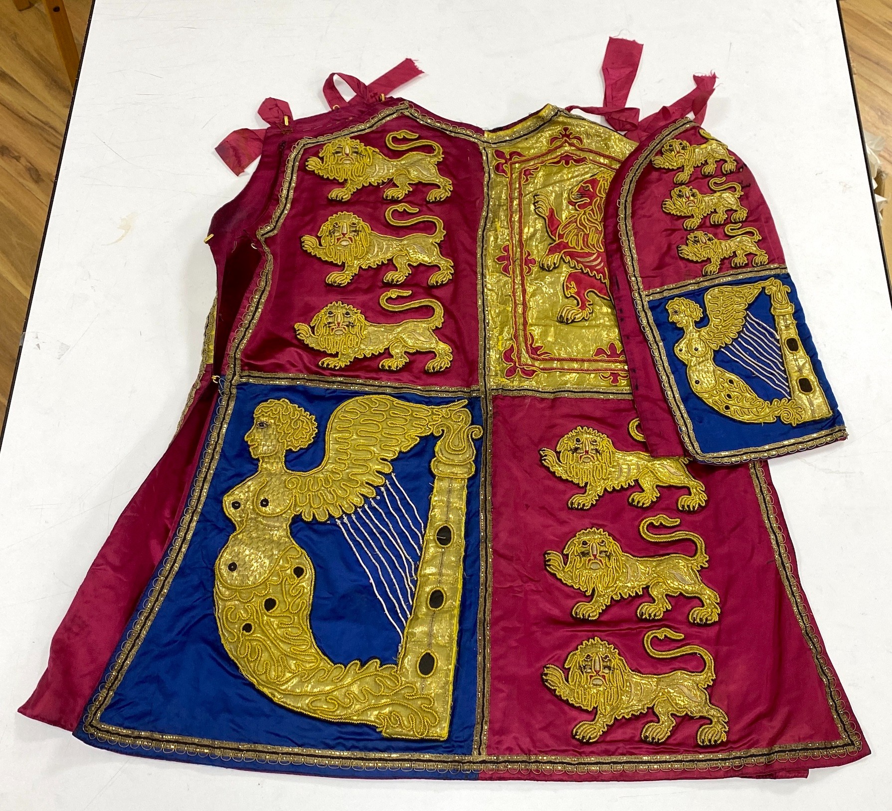 Two QEII Officer's of Arms of The Herald's College embroidered tabards and a similar silk garter, possibly worn for the Coronation of the Queen in 1953